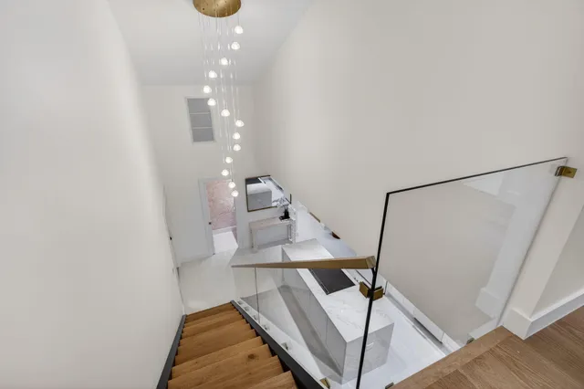 an aerial view of a house with a garden and lake view