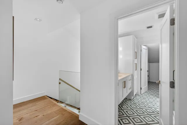 a front view of a house with a yard and potted plants