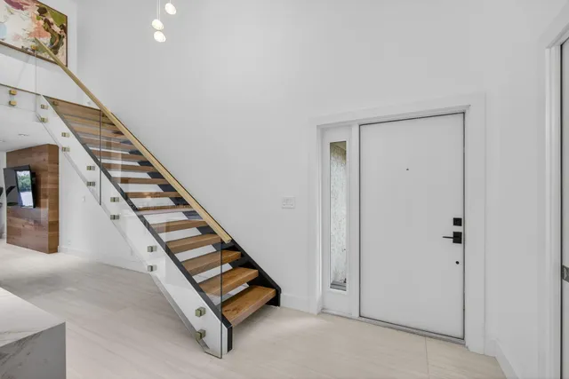 a kitchen with stainless steel appliances a sink a refrigerator a counter space and a window