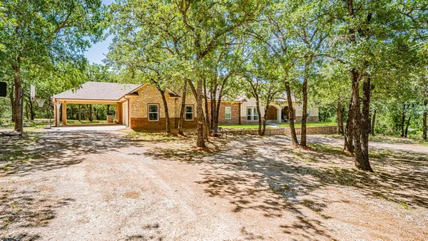 a view of a house with a tree in the background