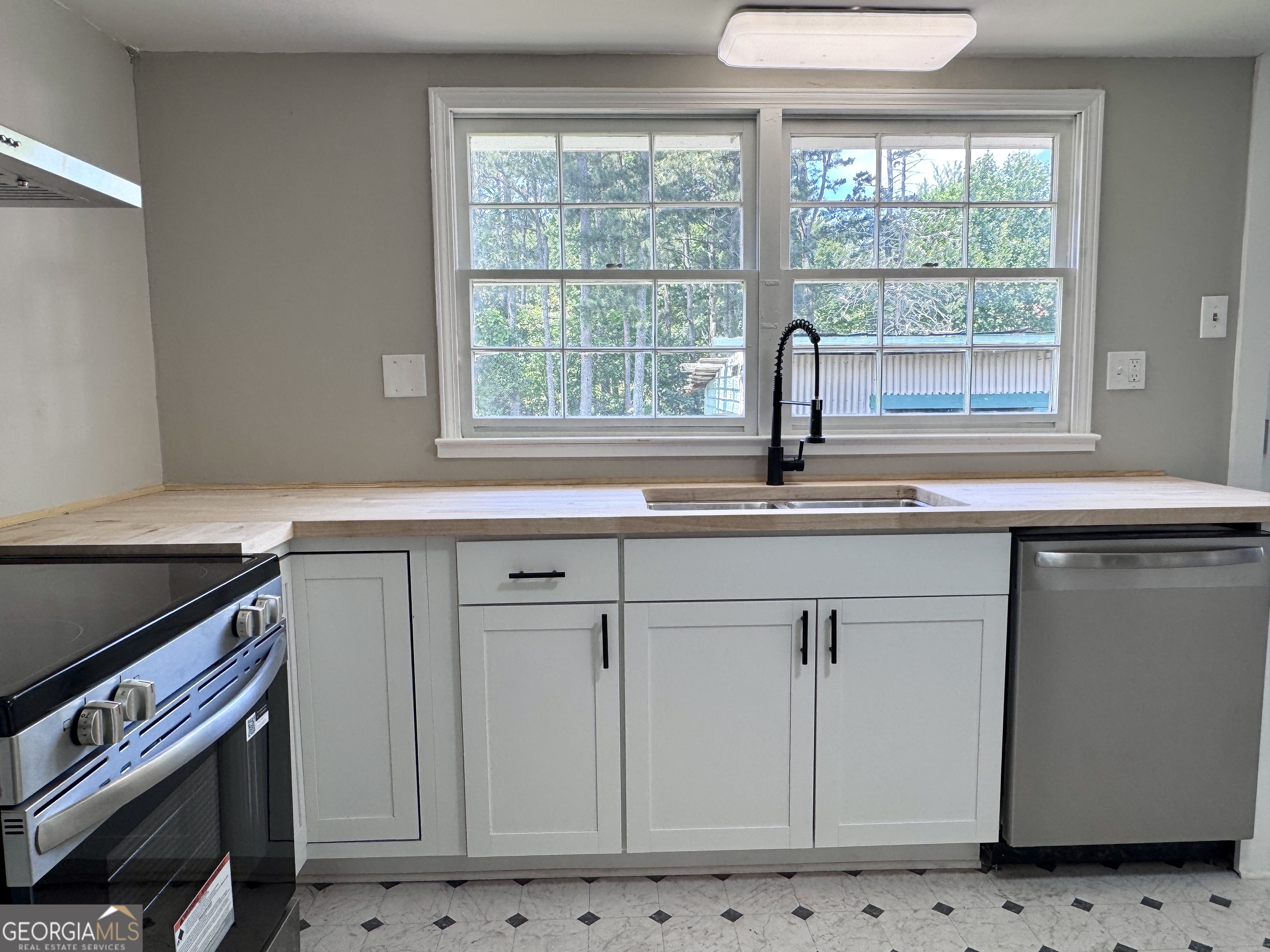 3608 Us Highway Buchanan, GA 30113 - Photo 7 of 51 a kitchen with granite countertop a sink a stove and a window