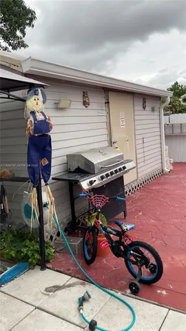a view of a patio with table and chairs and potted plants
