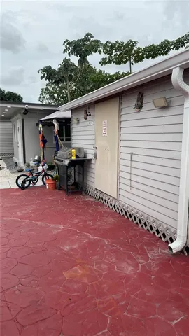 a backyard of a house with table and chairs