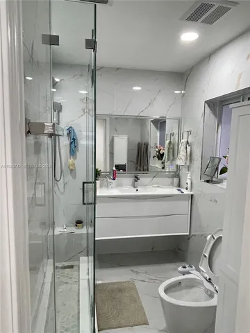 a spacious bedroom with a bed and a mirror