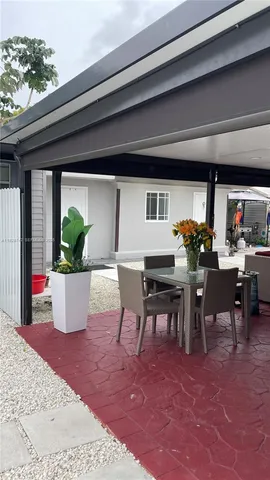 a view of a dining room with furniture and potted plant
