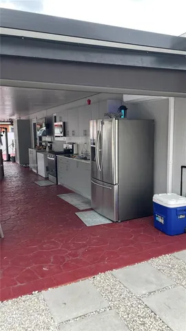 a kitchen with kitchen island a stove and a refrigerator