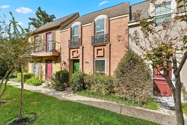 a view of a brick building next to a yard