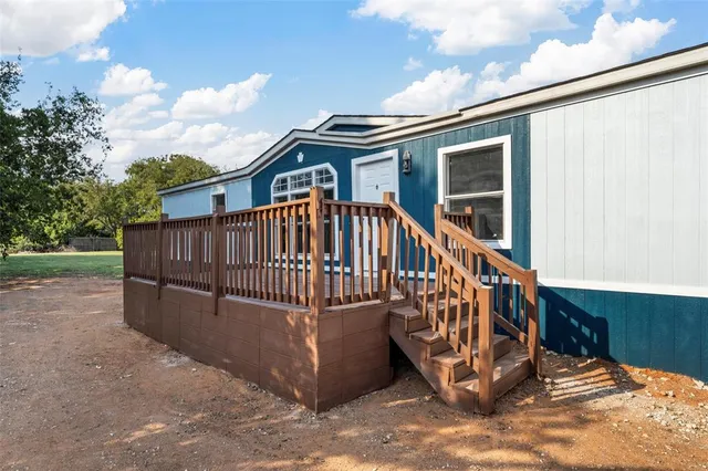 a view of a house with a wooden deck