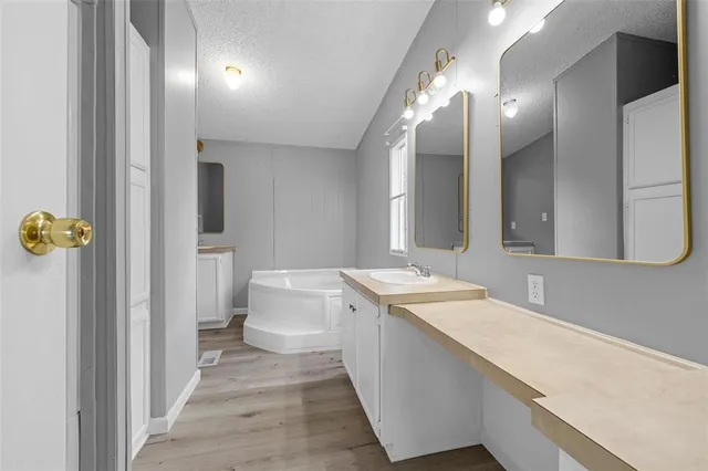 a bathroom with a sink and mirror with toilet