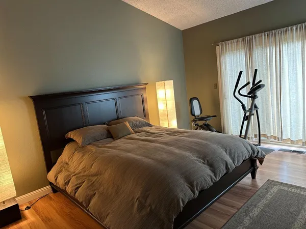 a view of a bedroom with a large bed and chandelier