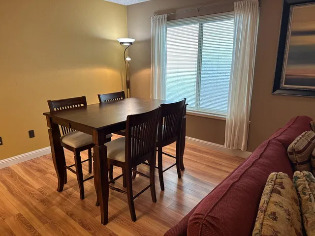 a kitchen with a table chairs and refrigerator