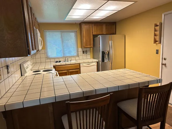 a kitchen with a stove sink and cabinets