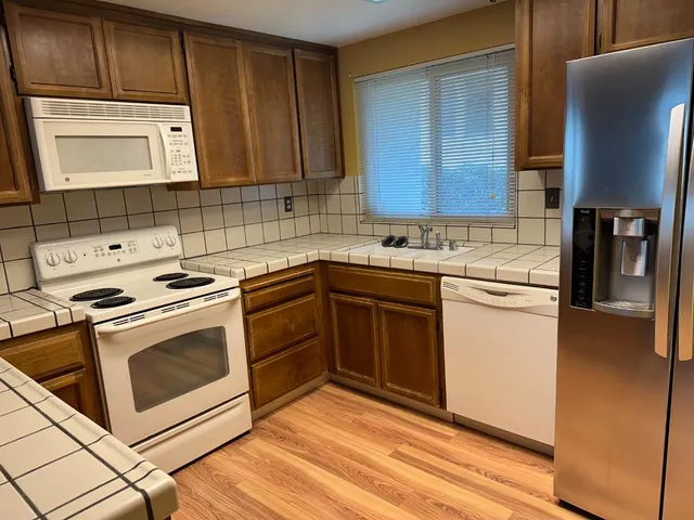 a kitchen with a sink stove and cabinets