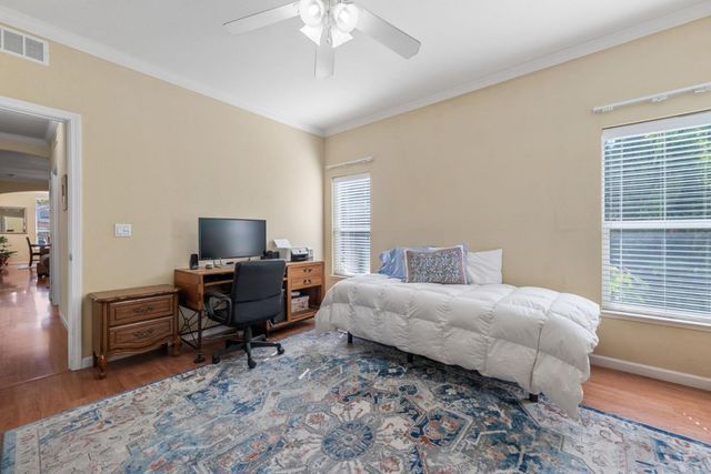a bedroom with furniture and a flat screen tv