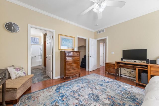 a bedroom with furniture and a flat screen tv