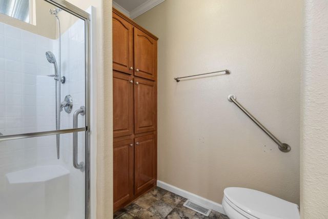 a bathroom with a toilet and a shower