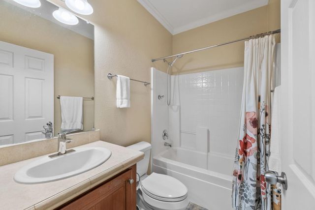 a bathroom with a sink toilet vanity tub and shower