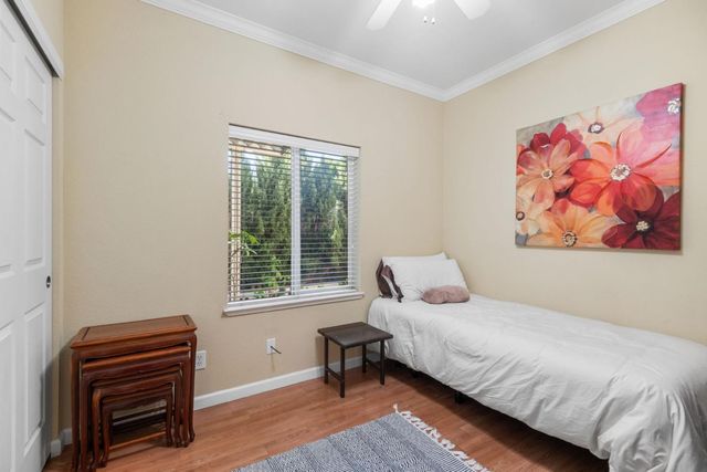 a bedroom with a bed and a piano next to a window
