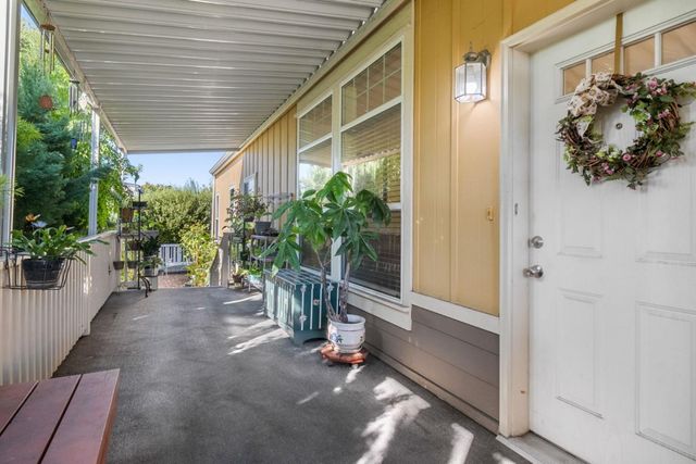a view of a porch with potted plants
