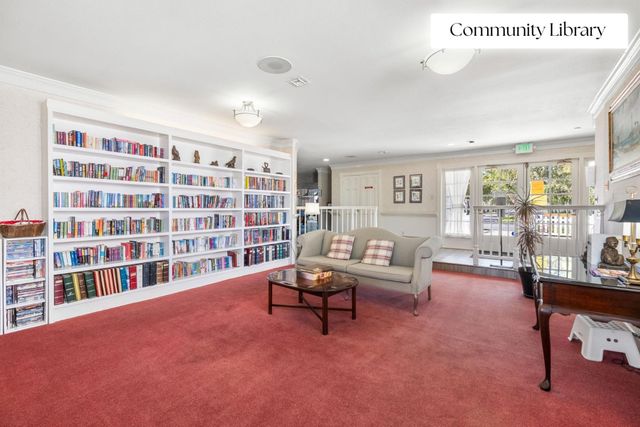 a living room with furniture and a book shelf