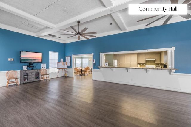 a view of a living room and kitchen with furniture