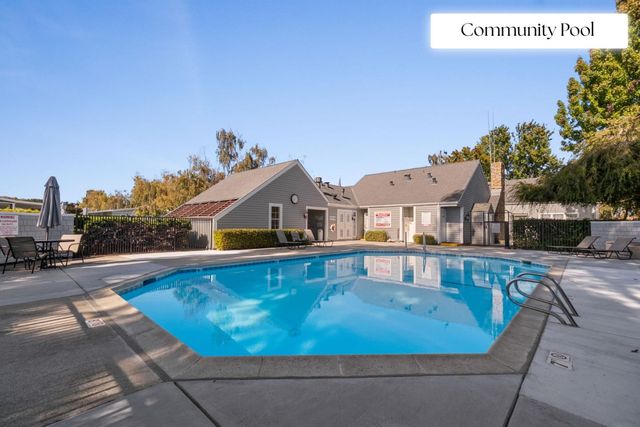 a swimming pool with outdoor seating and yard