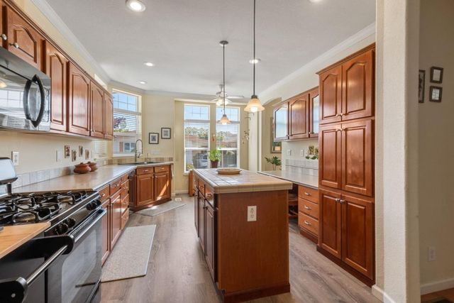 a kitchen with stainless steel appliances granite countertop a stove and a refrigerator