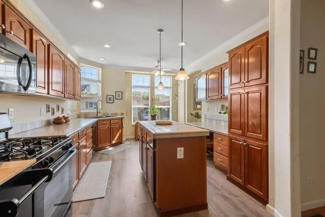 a kitchen with stainless steel appliances granite countertop a stove and a refrigerator