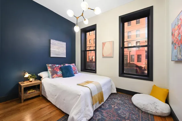 a bedroom with a bed couch and window