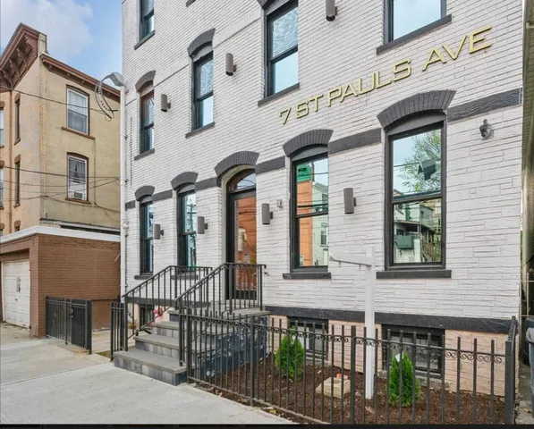 a front view of a brick building with large windows