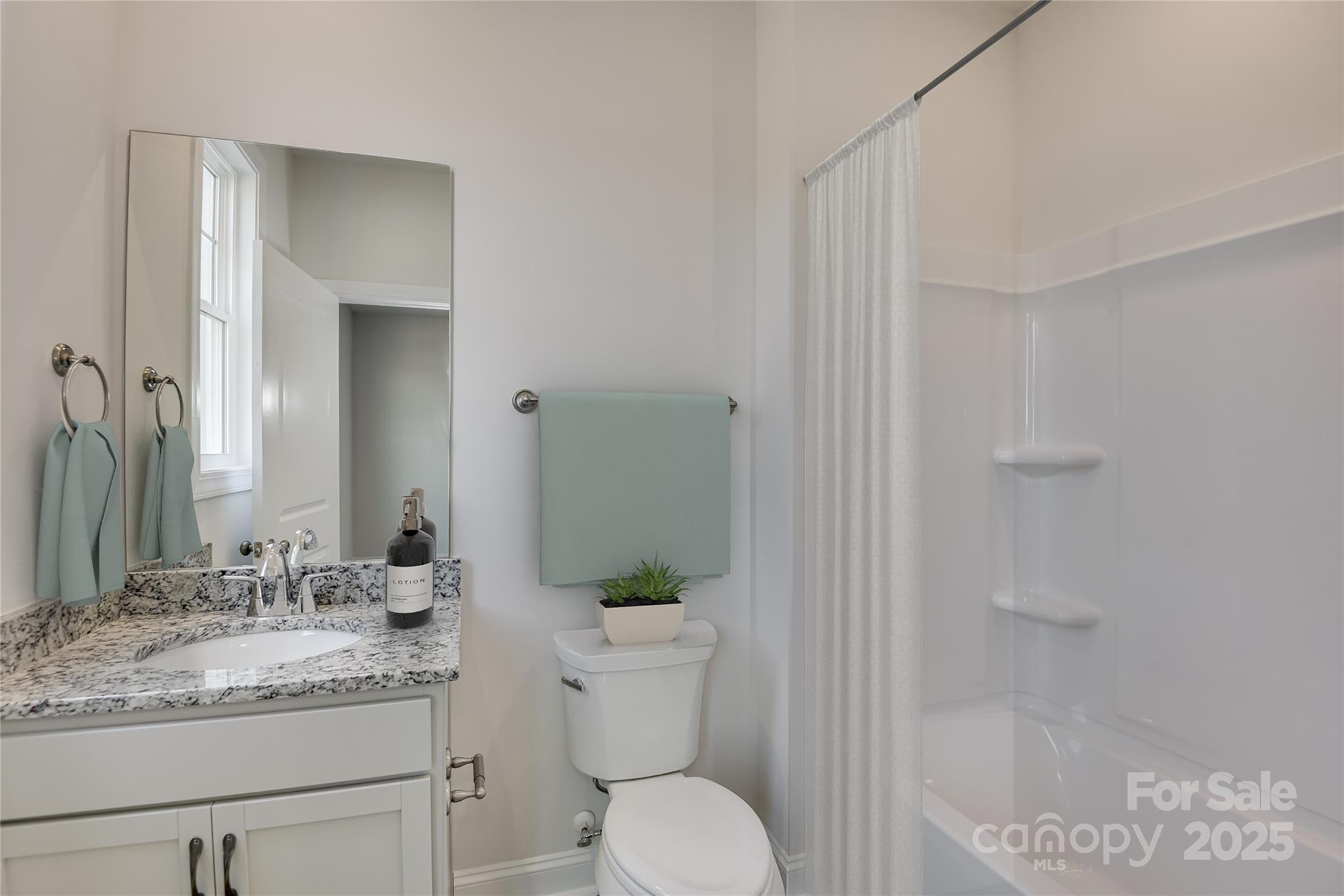 327 Alameda Way Matthews, NC 28104 - Photo 14 of 31 a bathroom with a granite countertop sink a toilet and shower
