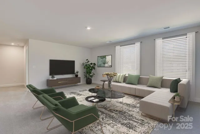 a living room with furniture a flat screen tv and a large window