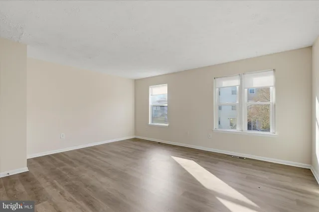 a view of an empty room and wooden floor