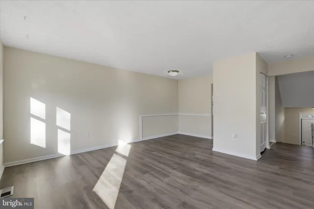 a view of a kitchen with an empty space and a window