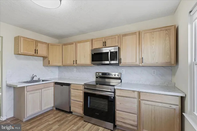 a white refrigerator freezer sitting inside of a kitchen