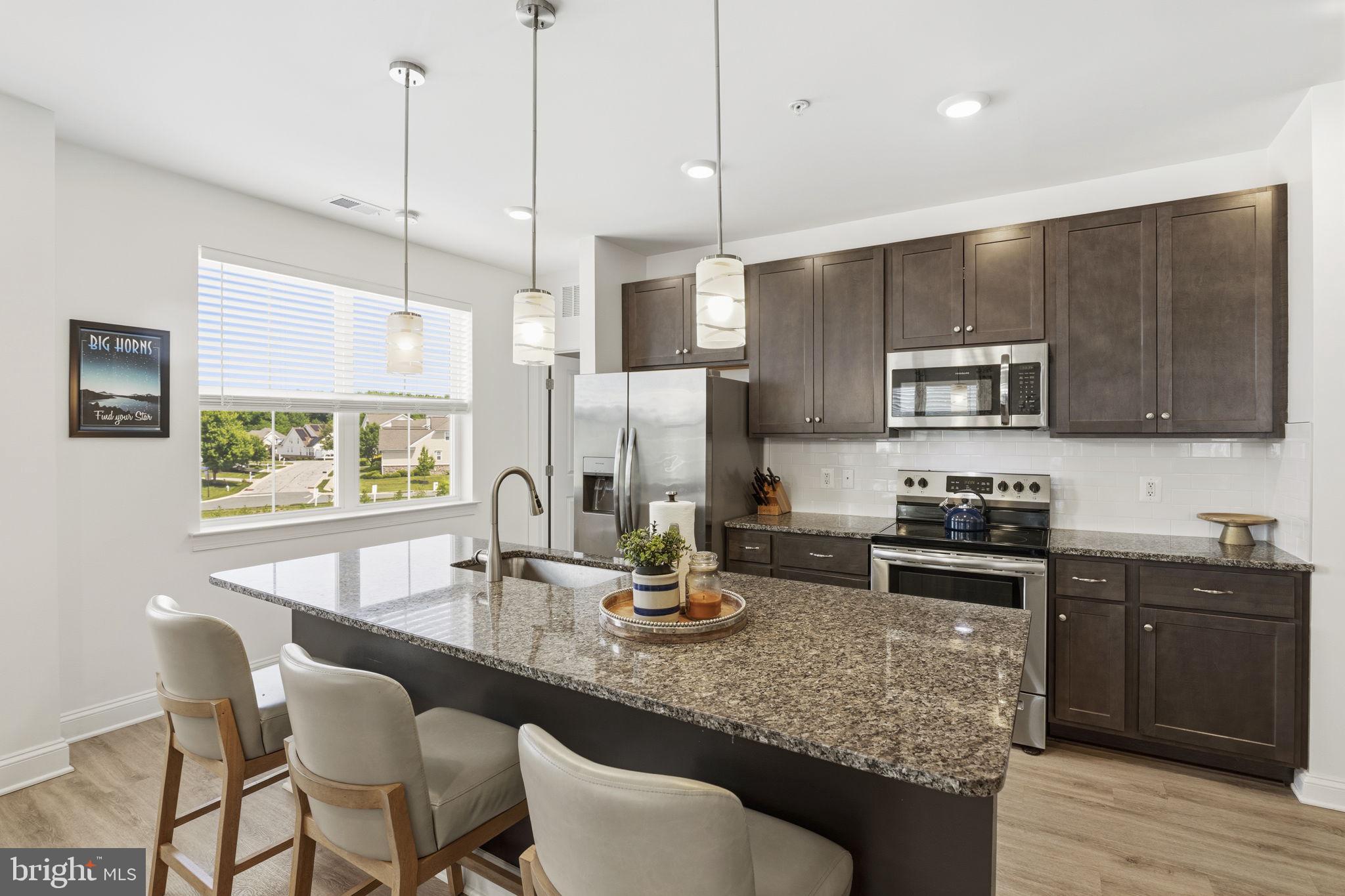 401 Bold Ruler Court, Unit 307 Havre de Grace, MD 21078 - Photo 20 of 32 Pendant lighting over island w/ seating