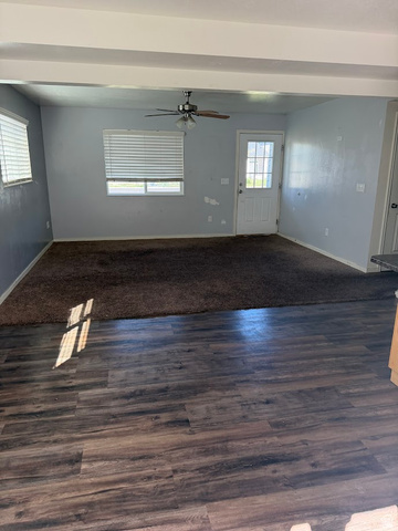 695 West 760 South Logan, UT 84321 - Photo 2 of 5 Unfurnished living room with dark wood-style floors and a ceiling fan