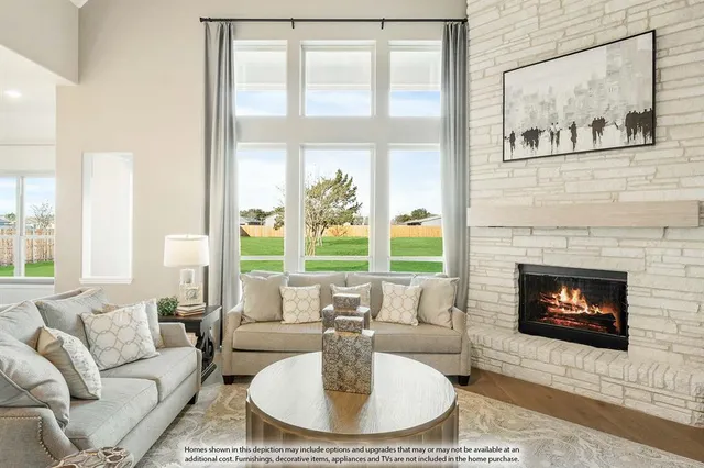 a living room with furniture a fireplace and a large window