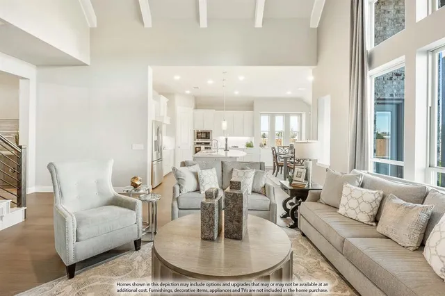 a living room with furniture and a dining table with kitchen view