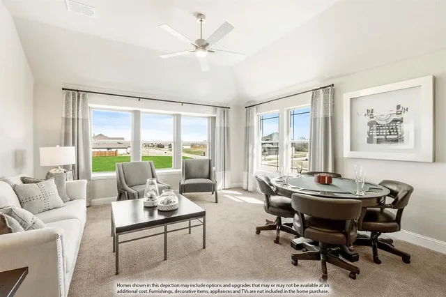 a living room with furniture and large windows