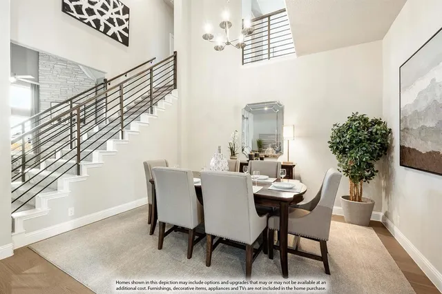 a view of a dining room with furniture and a potted plant
