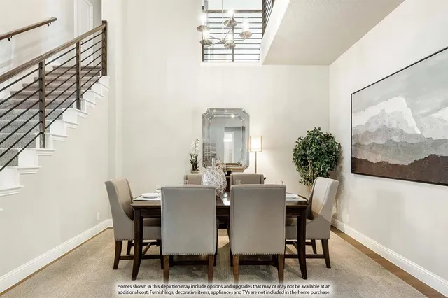 a view of a dining room with furniture and a potted plant