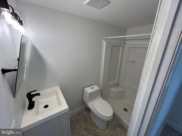 a white toilet sitting next to a bathroom sink