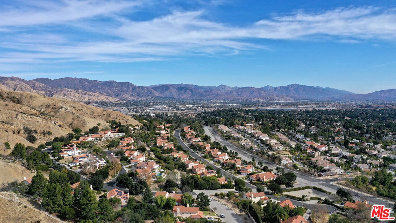 an aerial view of residential house and mountains