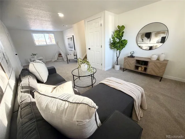 a living room with furniture and a large mirror