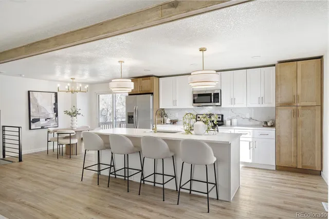 a kitchen with granite countertop cabinets and wooden floor