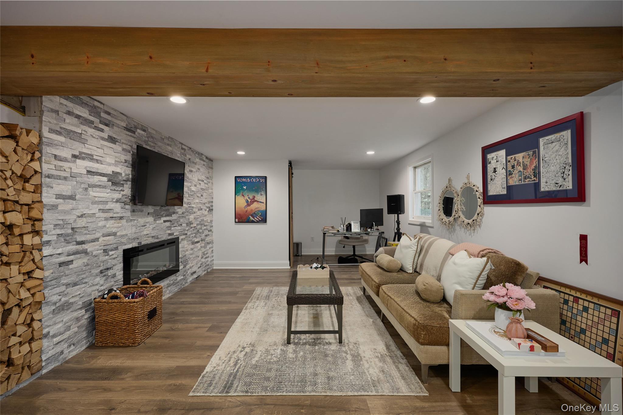 4 Elmer Galloway Road Katonah, NY 10536 - Photo 46 of 49 Stacked stone accents, exposed wood beams, & electric fireplace create a warm and inviting space for relaxing or entertaining