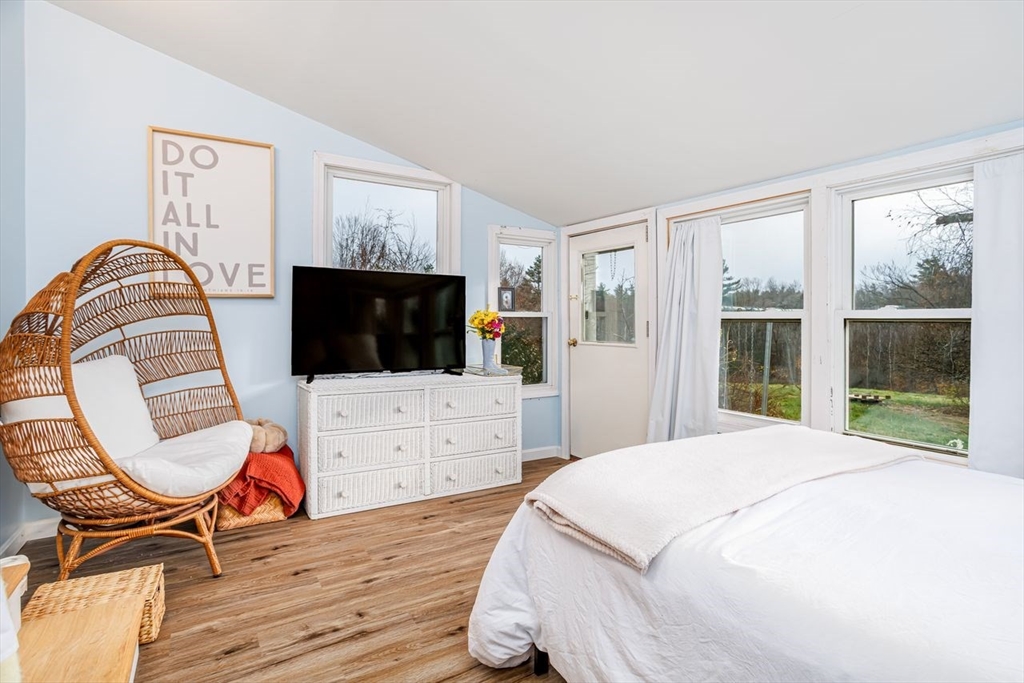 155 County Road Ashby, MA 01431 - Photo 30 of 38 a bedroom with a bed and a flat screen tv