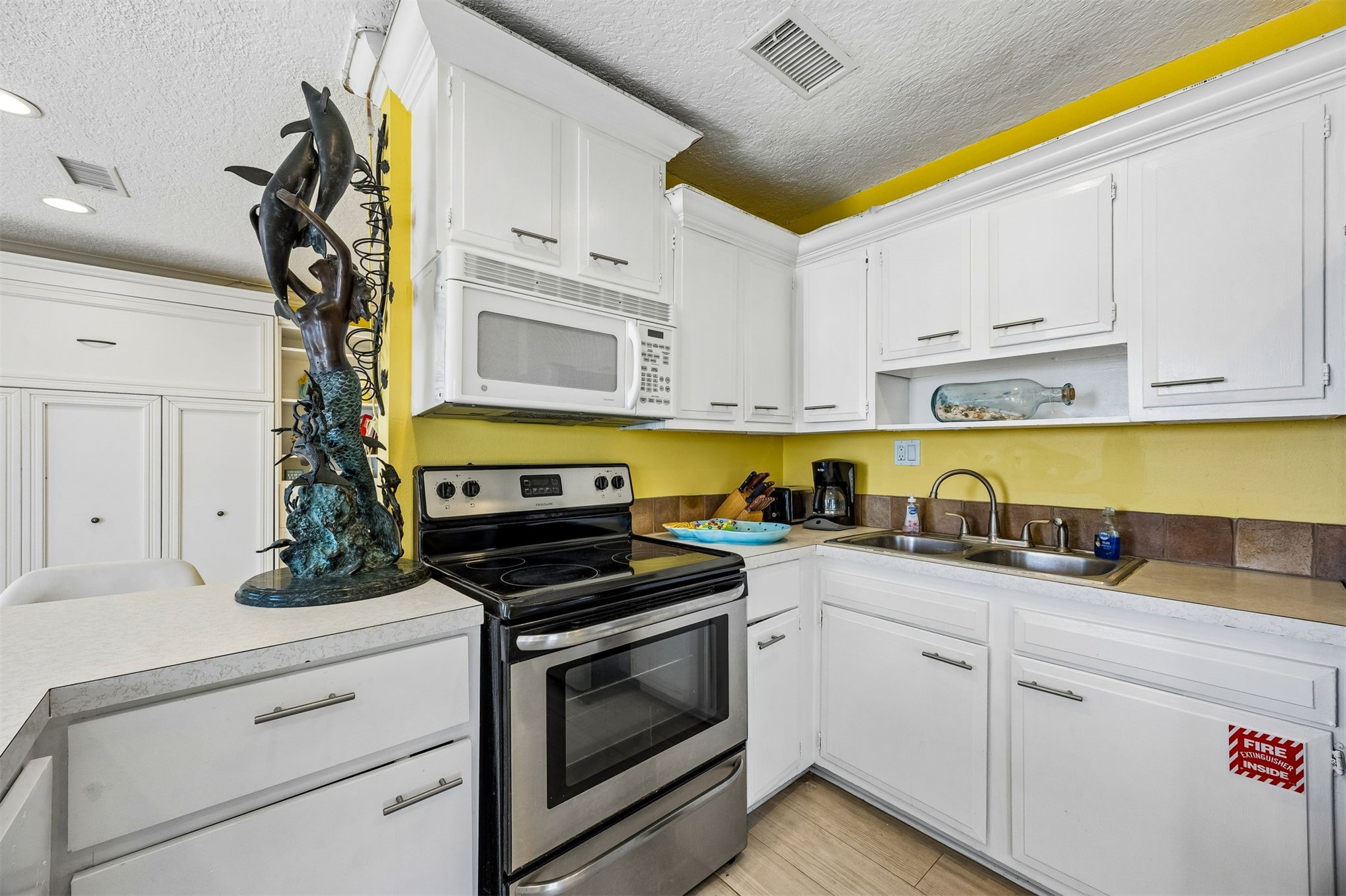 1990 South Fletcher Avenue Fernandina Beach, FL 32034 - Photo 22 of 47 a kitchen with white cabinets and appliances