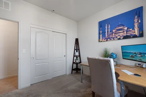 a bedroom with a bed and a potted plant
